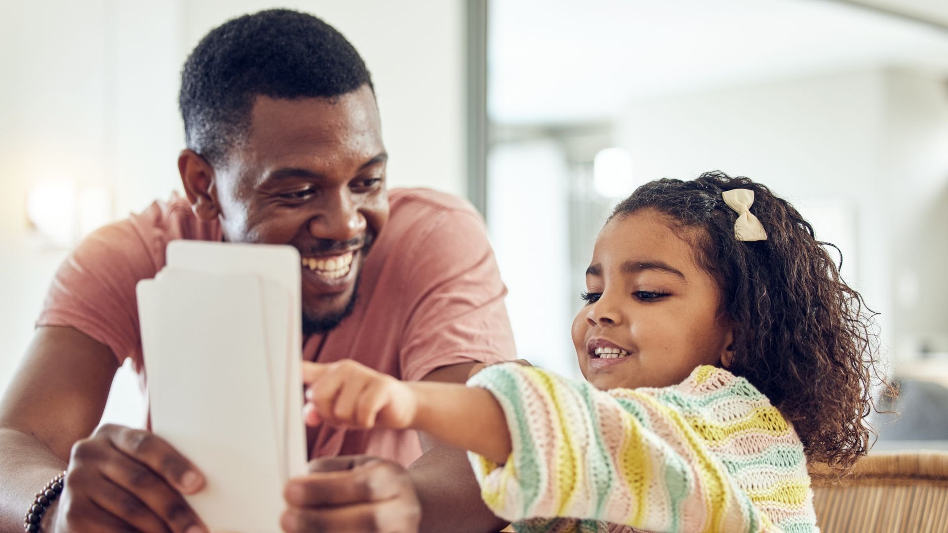 Father helping child with flashcards for sight words – Science of reading