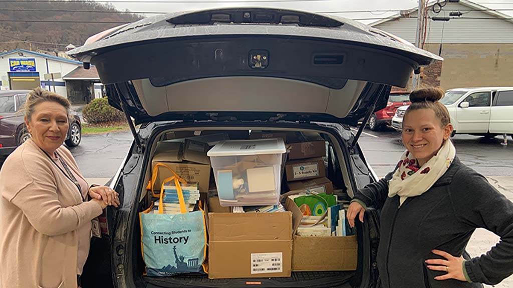 Educators leave Lincoln Learning's Great Book Giveaway with trunks full of free books.