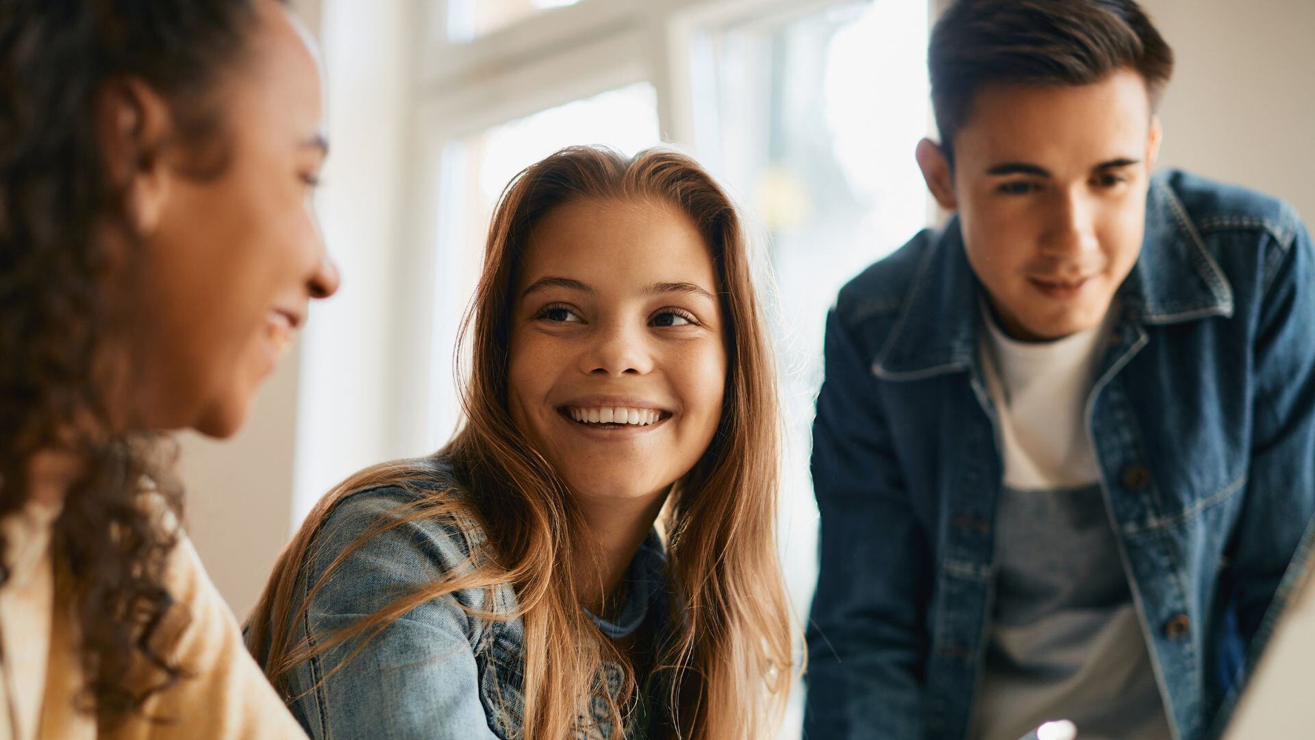 High school students smiling partaking in honors courses. 