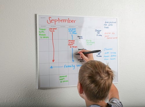 Kid writing on calendar