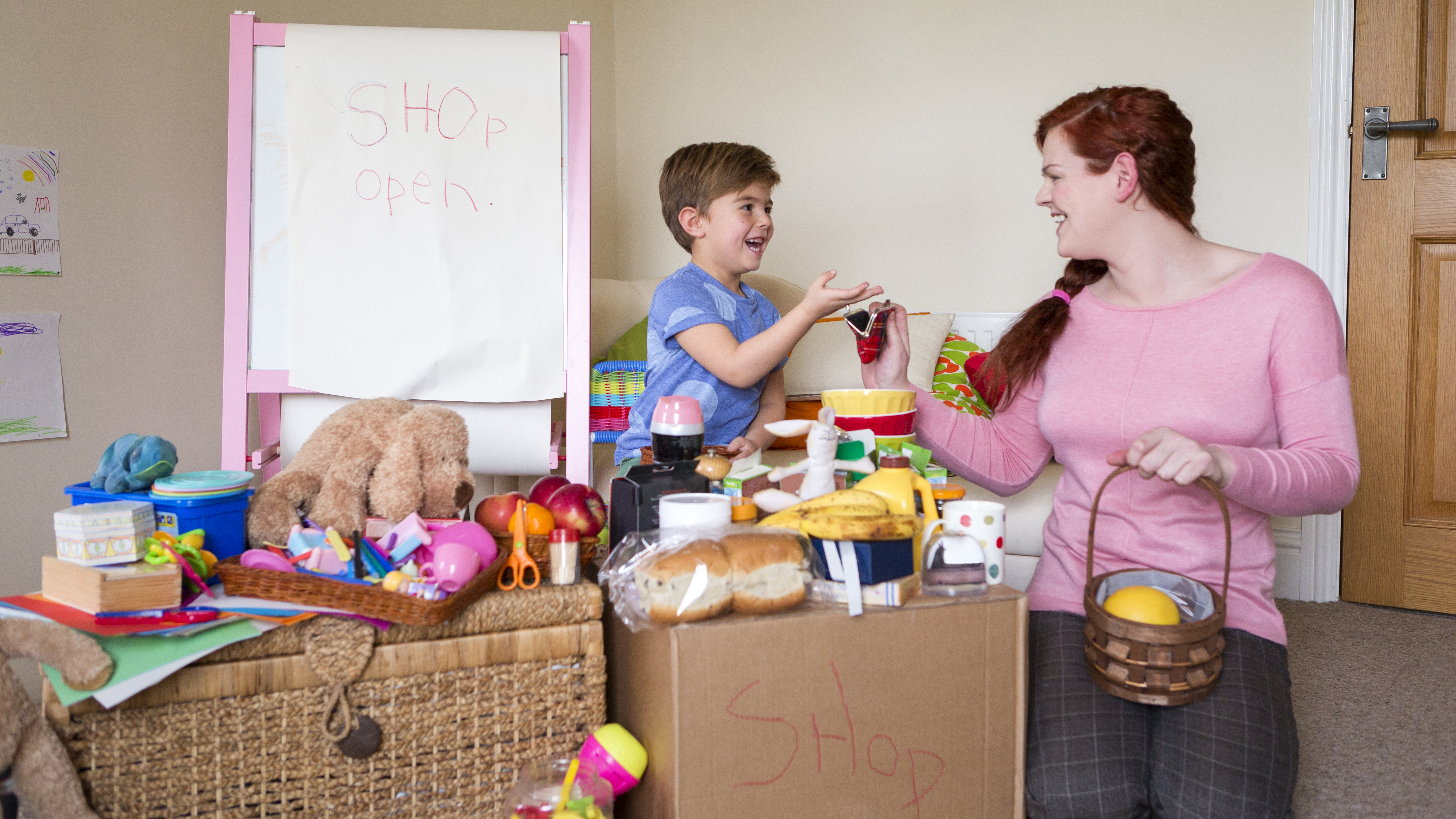 boy and mom playing store