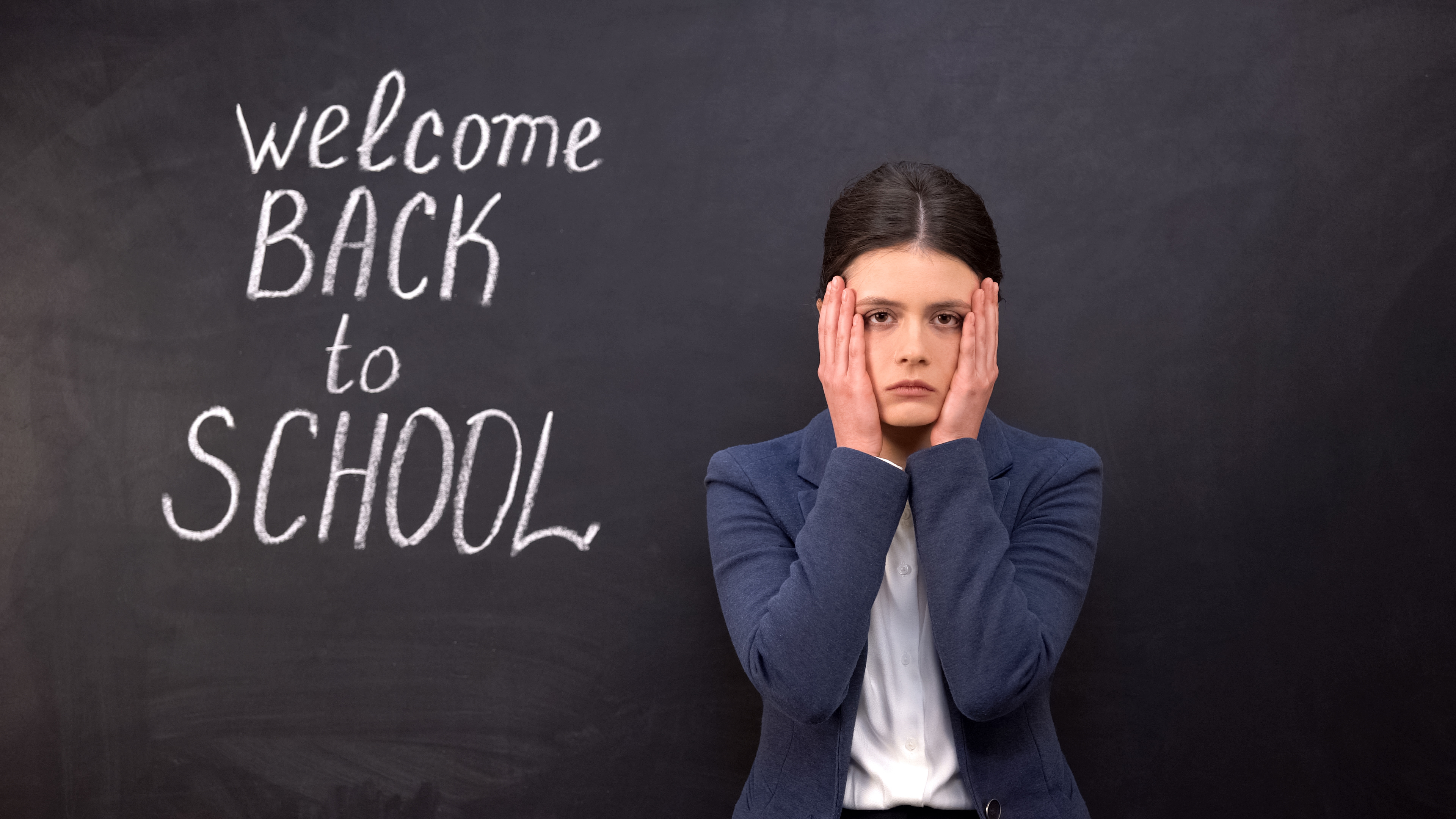 Distressed teacher in front of blackboard 